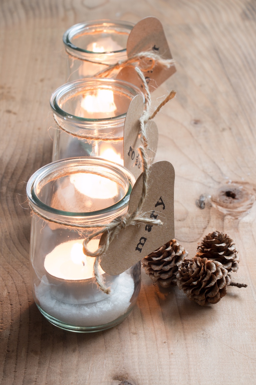 Friendsgiving table decoration idea. Ask everyone to write the name of someone who they are thankful for and tie to a glass votive for your centerpiece.